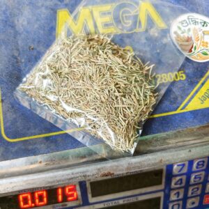 Packaged herbs on a digital scale with 'MEGA' branding